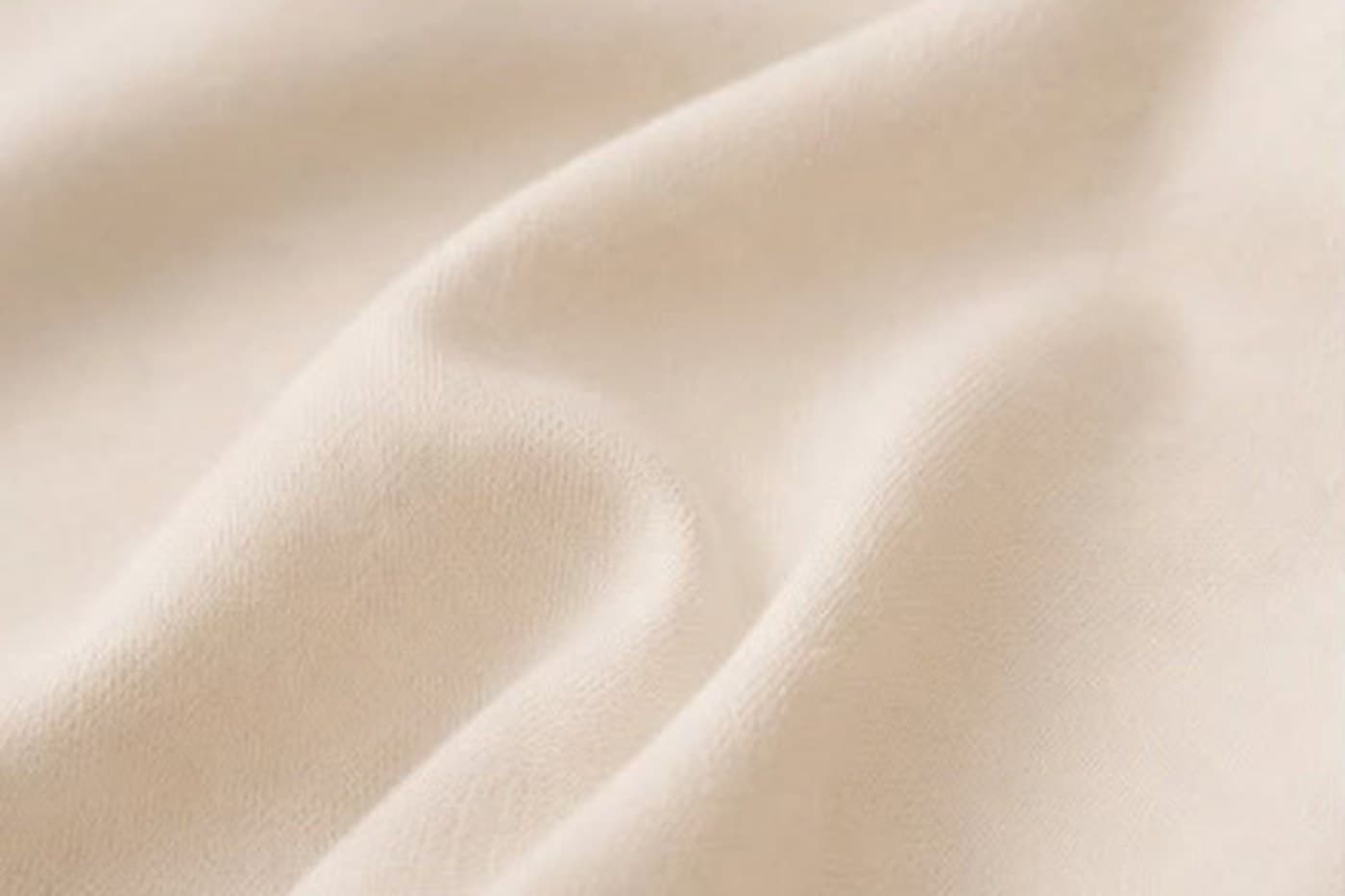 Macro photograph of the Blanc+ cotton-blend knit showing its surface texture